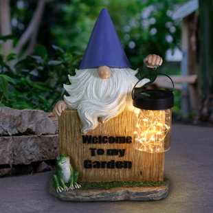 Exhart Solar Hand Painted Gnome Statue with a Lantern Jar of LED Fireflies by a Welcome Fence