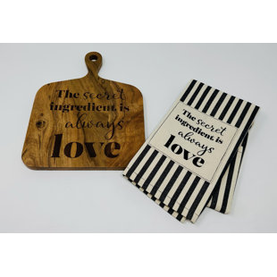 DREW DEROSE DESIGNS Square Cutting Board With Black Striped Tea Towel With The Words Secret Ingredient Is Always Love