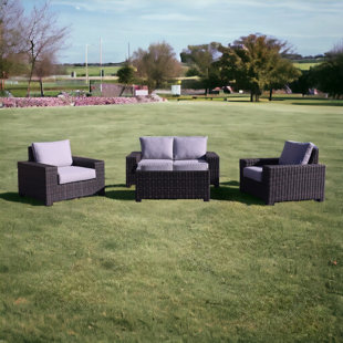 COURTYARD CASUAL FURNITURE 4 Piece Rattan Sofa Seating Group with Cushions