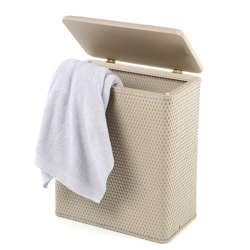 A tan upright wicker laundry hamper with a white towel hanging from it. 
