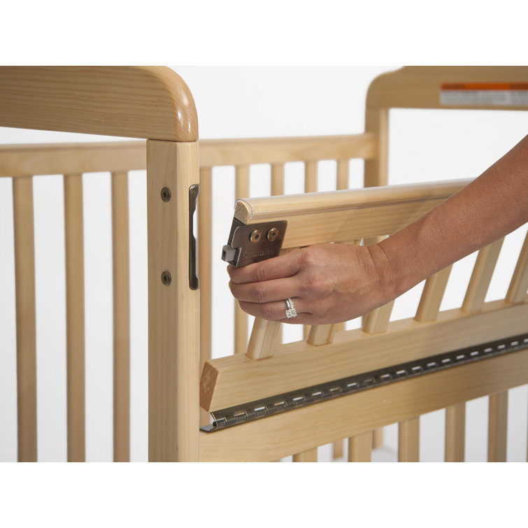 crib with fold down side