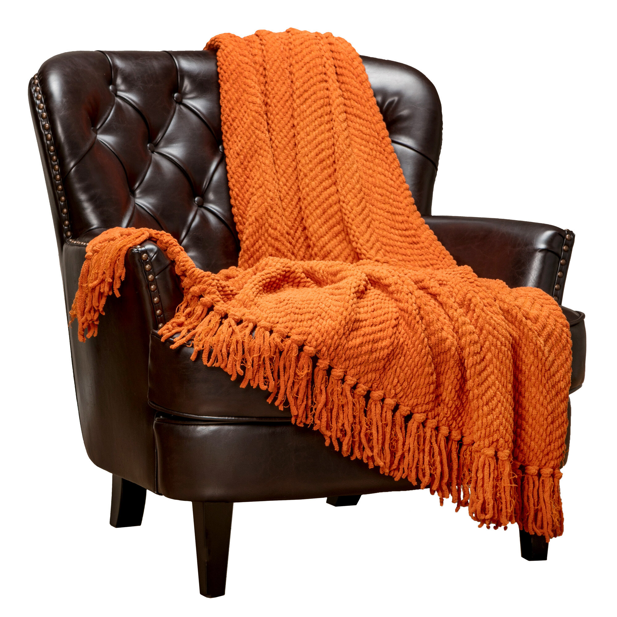 orange throw blanket and pillows