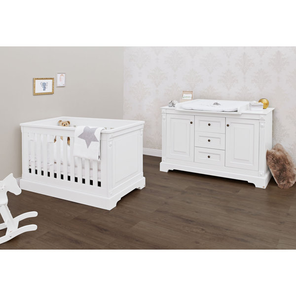white cot and changing unit