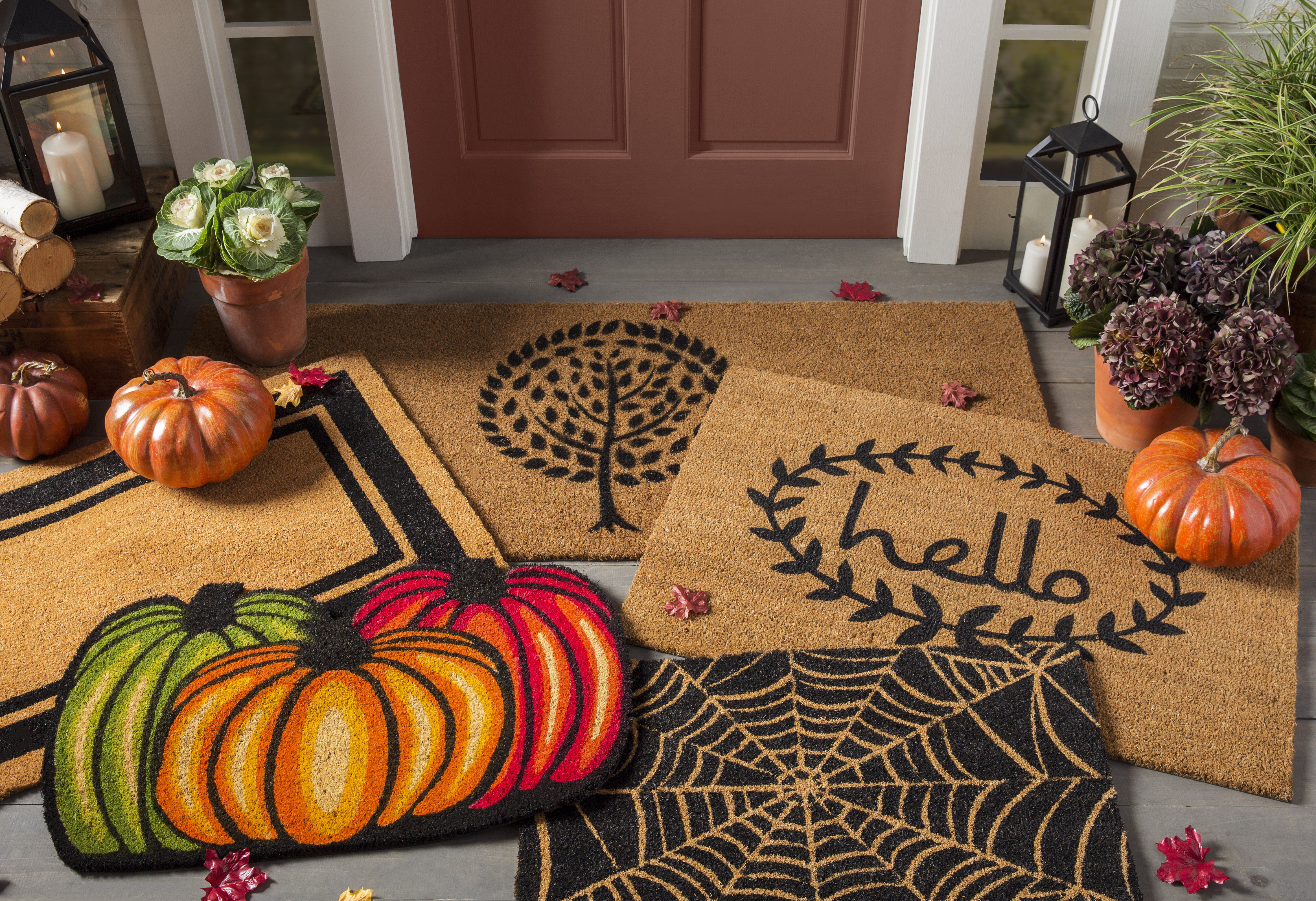Halloween-themed doormats layered atop each other