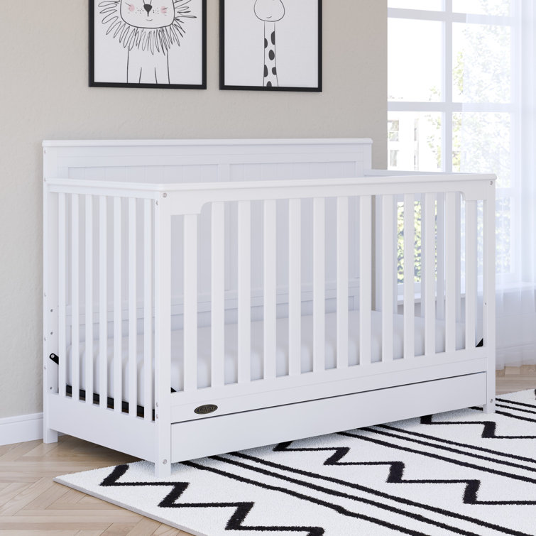 white cot with storage