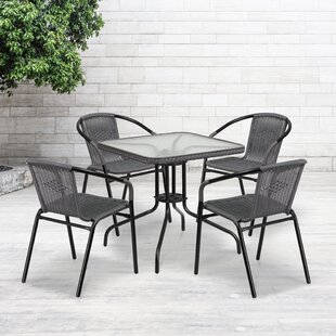 glass patio table with four chairs