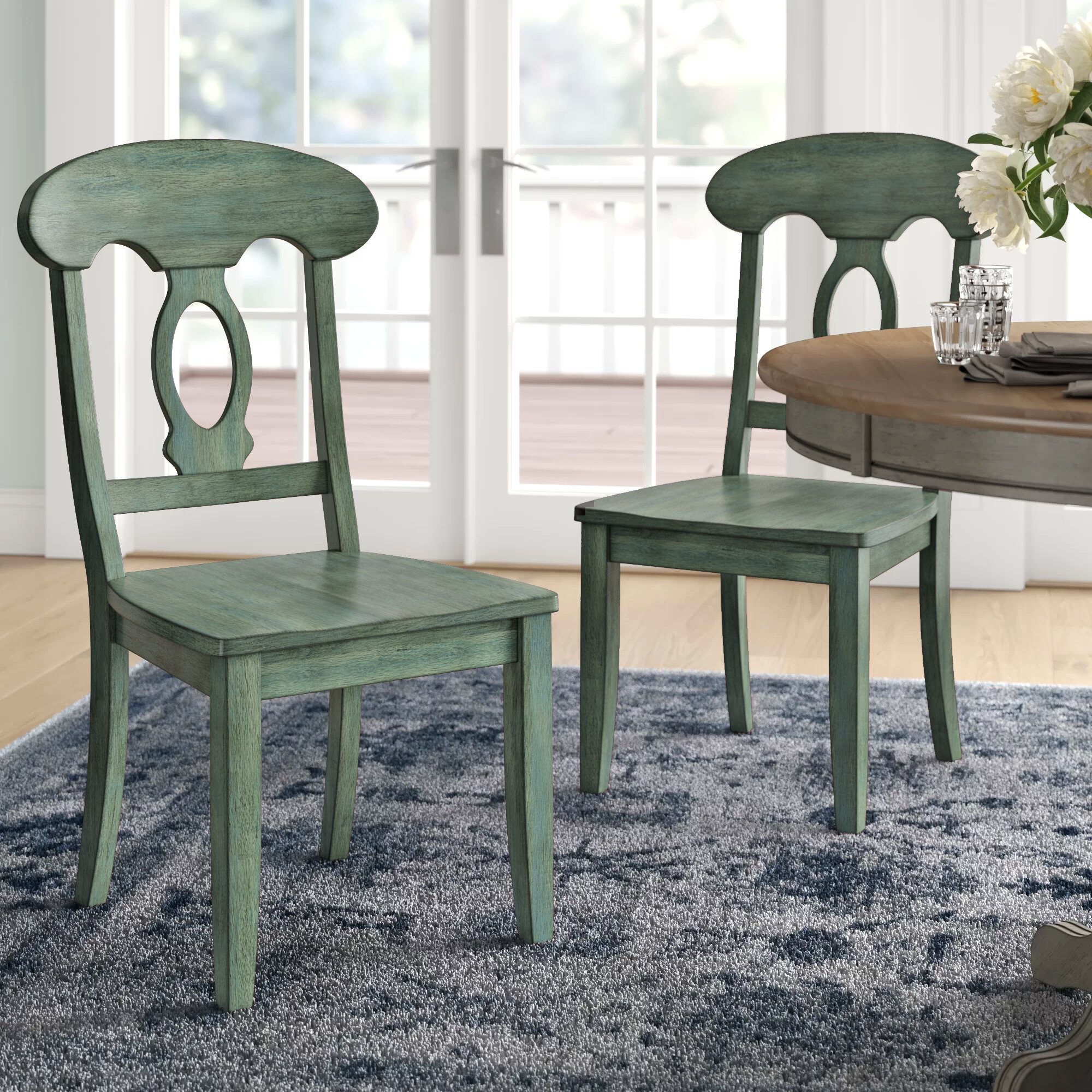 green wooden dining chairs