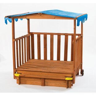 outdoor playhouse with sandbox