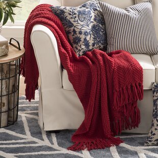 red throw blanket and pillows