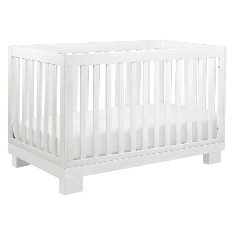 white crib with wood x on side