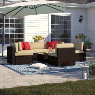 View Carmelo 7 Piece Rattan Sectional Seating Group with Cushions