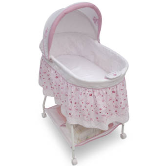 pink moses basket with drapes