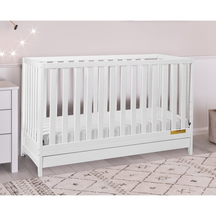 white cot with storage