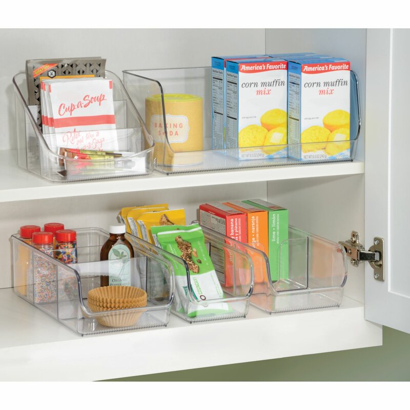 A white cabinet with clear storage containers filled with various pantry items. 