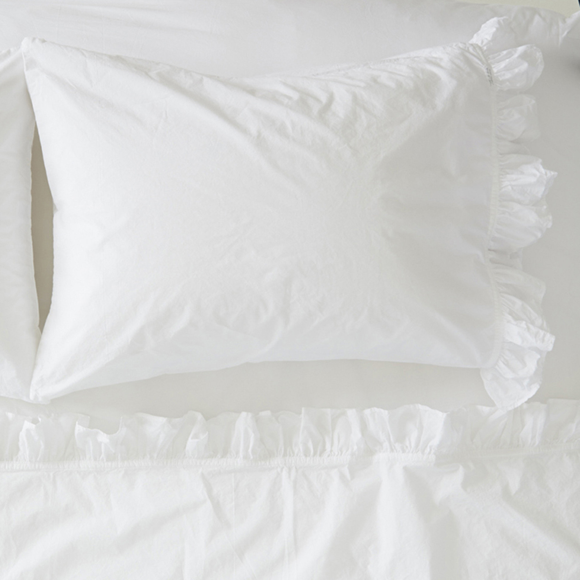 white ruffle pillow case