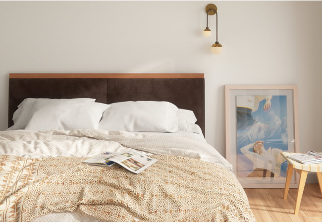 Close up of large bed with a bulky comforter and large pillows.