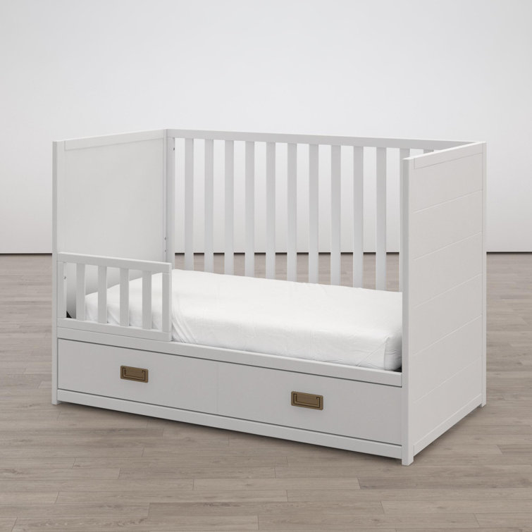 white cot with storage