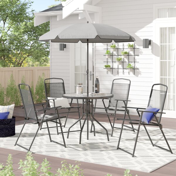 small outdoor table and chairs with umbrella