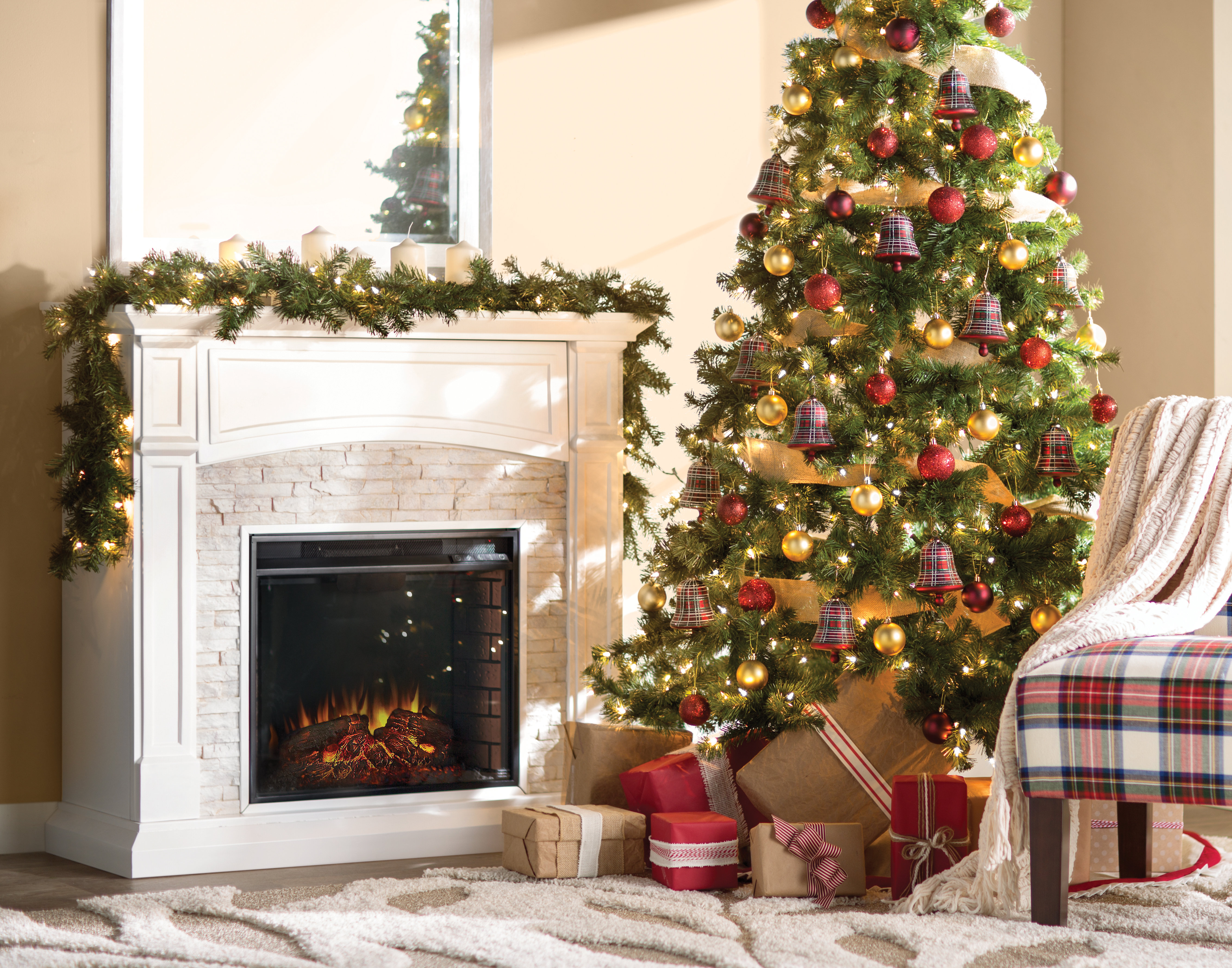 Red and gold christmas tree facing lit hearth