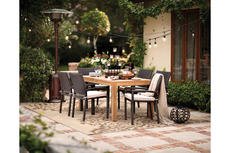 patio with full dining table and overhead string lights