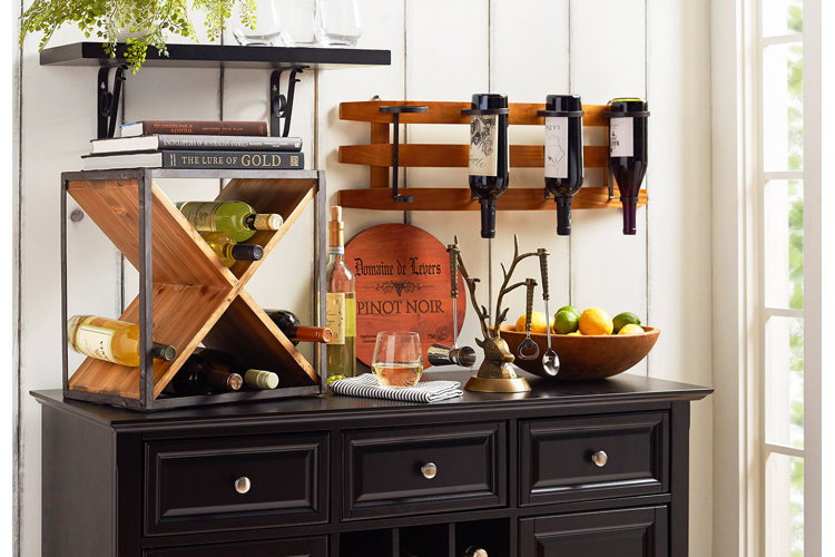 two separate wine racks holding wine alongside bar tools