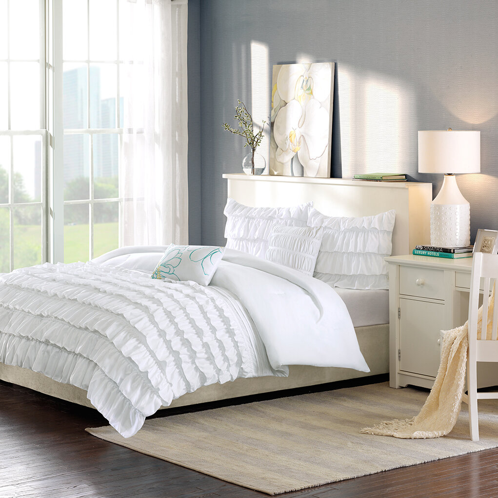 white bedding with throw pillows