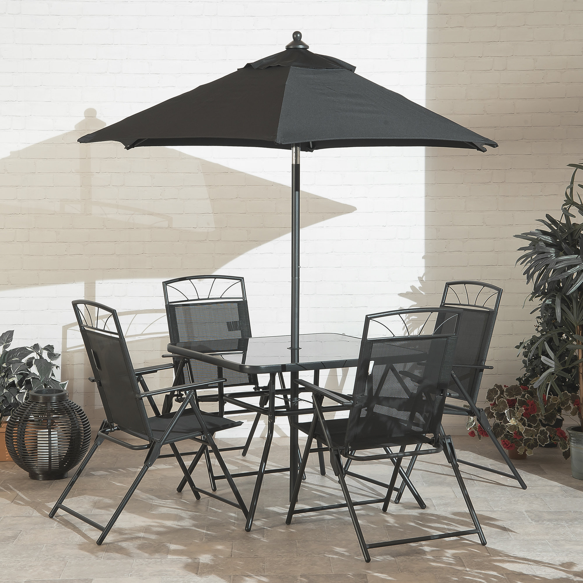 round patio table with chairs and umbrella