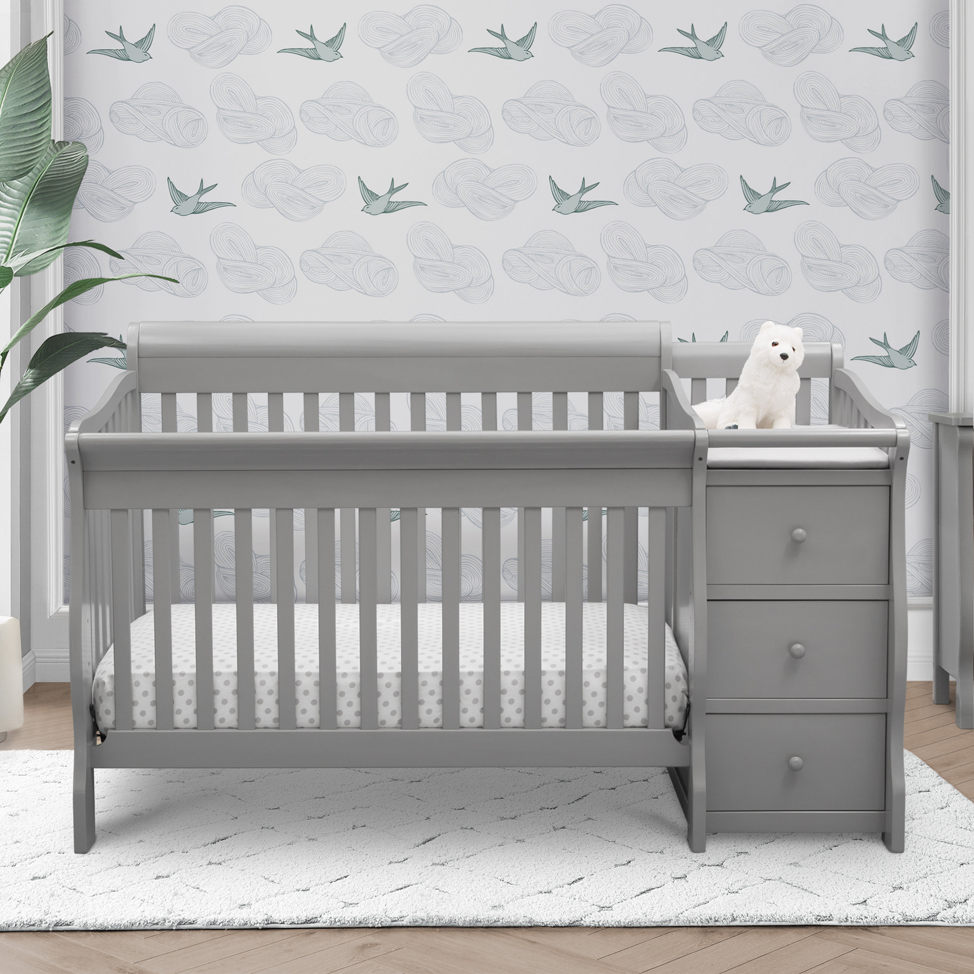 gray crib and changing table